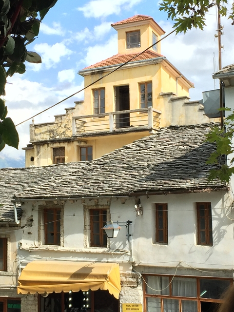 Traditional stone house with a unique roof design.