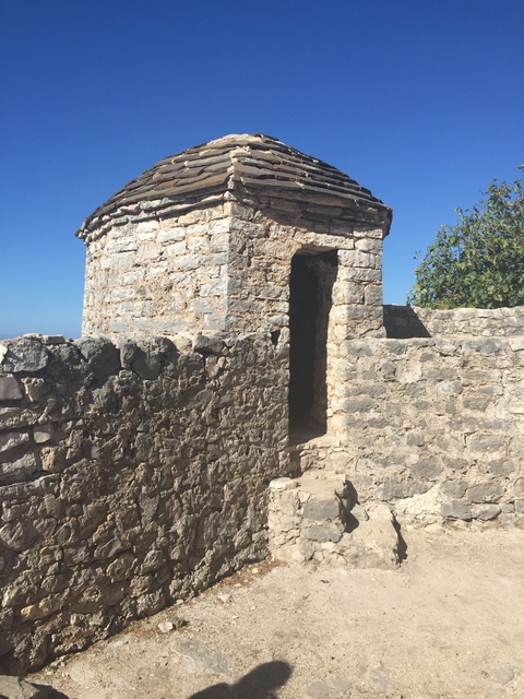 Small stone building with a doorway.