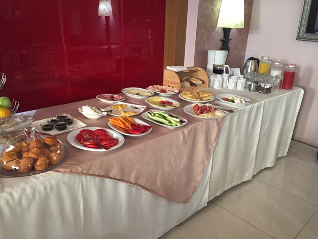 Buffet table with various foods and drinks.
