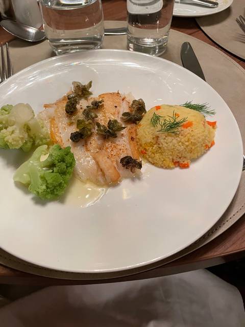 Dish with fish, couscous, and vegetables.