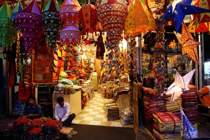 Vibrant textile market stall with hanging decorations.