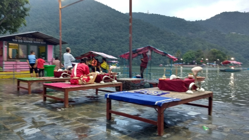 Blurry image of people at a lakeside market.