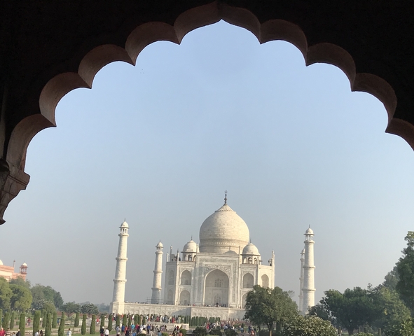 Framed view of the Taj Mahal through an archway.