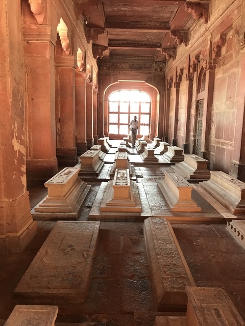 Indoor tombs with a person standing at the far end.