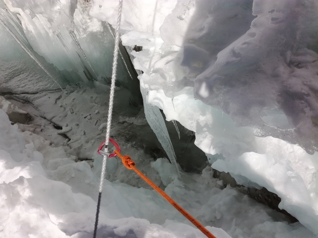 Close-up of climbing gear secured on a glacier.