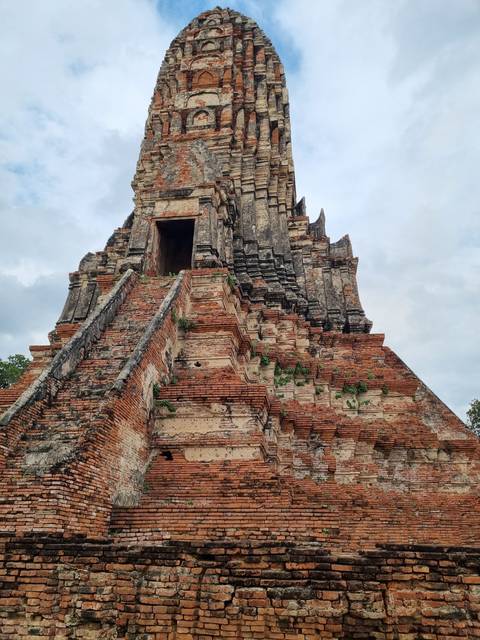 Ancient brick temple ruins under a cloudy sky.
