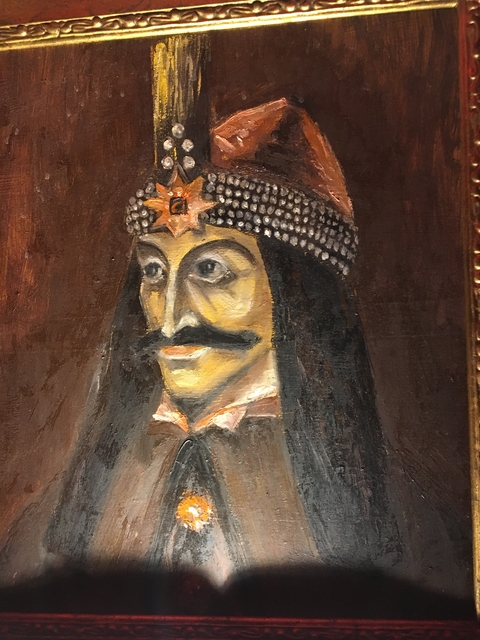 A painting of a historical figure wearing a ornate headpiece.