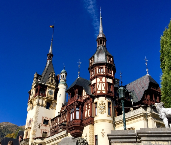 A grand castle with architectural details against a clear blue sky.