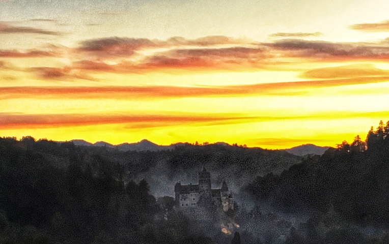 A castle silhouette against a vibrant sunset with colorful clouds.