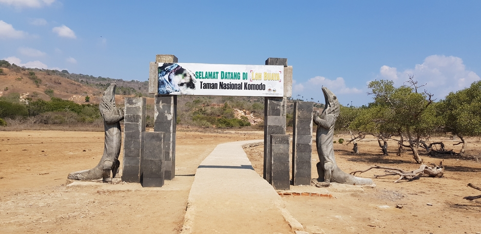 Entrance to a national park with sculptures and signage.