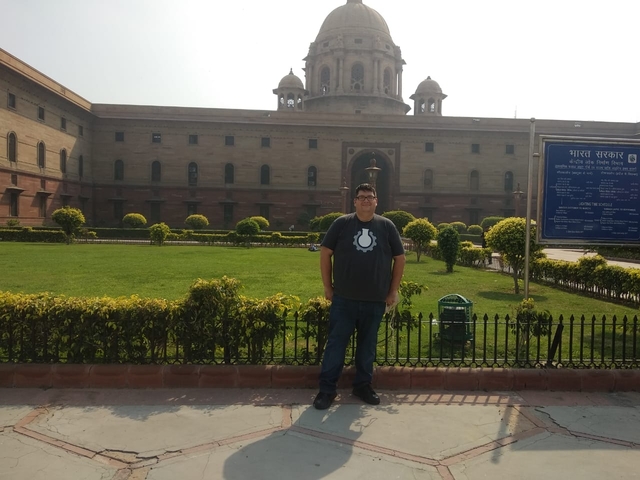 Man standing in front of historic government building