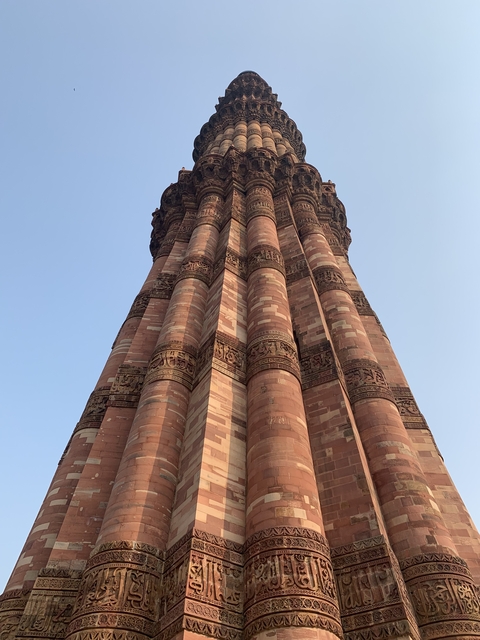 Close-up view of Qutub Minar tower with intricate carvings.