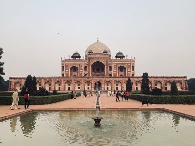 Humayun's Tomb with lush gardens and visitors.