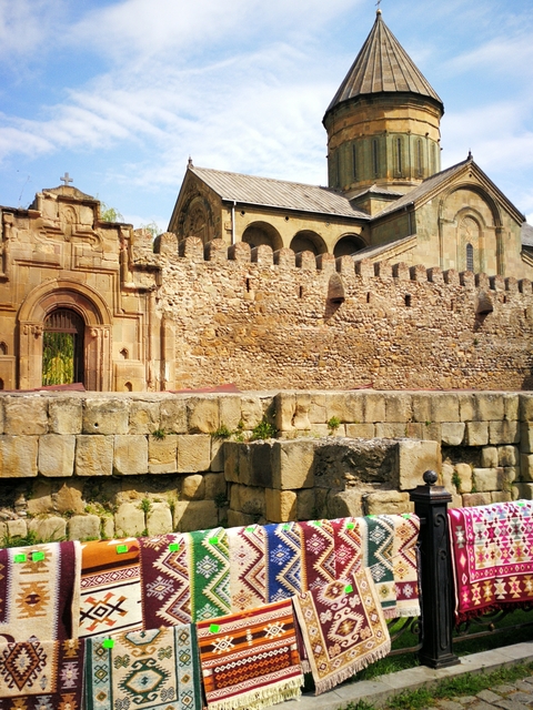 Details of an ancient stone fortress with intricate carvings.