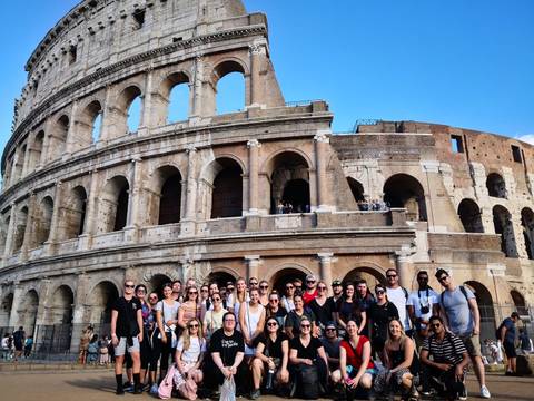 Large group posing in front of the Colosseum.