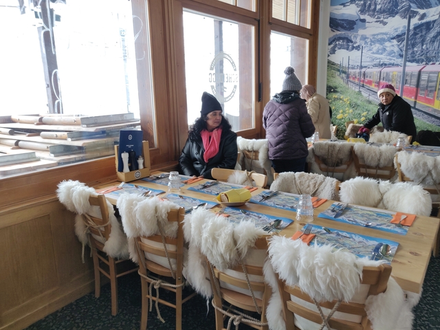 People sitting at a table in a cozy mountain restaurant.