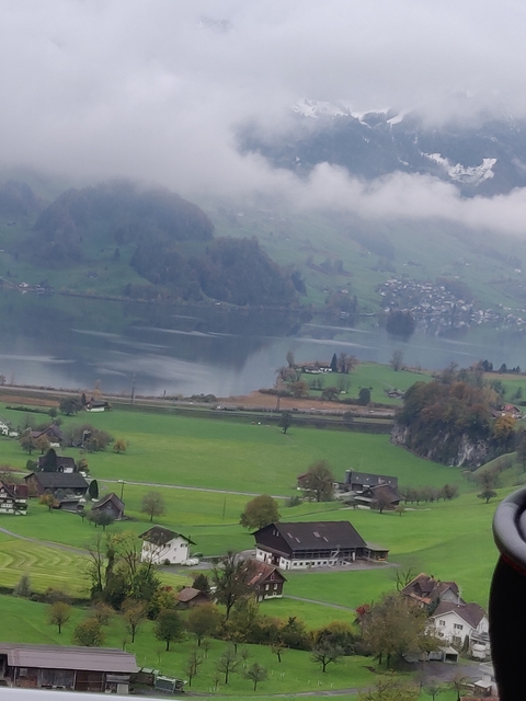 Countryside landscape with hills and a lake.
