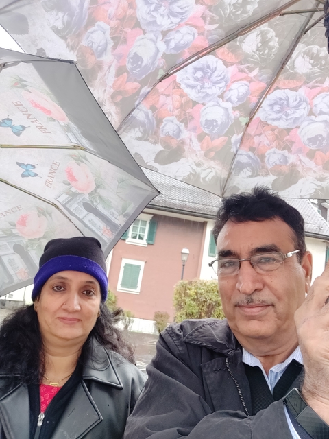 Couple with umbrellas on a rainy day.