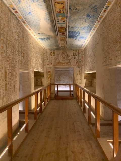 Interior of an ancient Egyptian tomb with hieroglyphs.