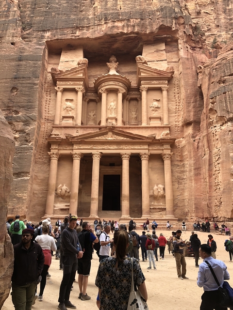 The facade of a grand ancient building carved into rock.
