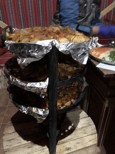 Cooking skewered meat in a traditional style oven.