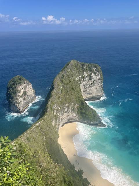 Cliffside view of the ocean and beach.