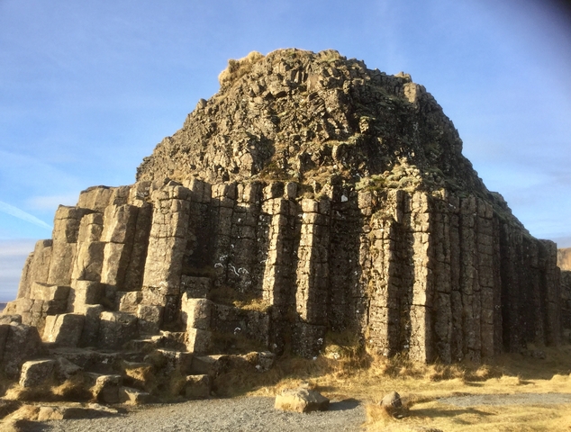 Geological rock formations with a clear blue sky above.