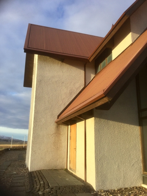 Close-up of a building's roof section against the sky.