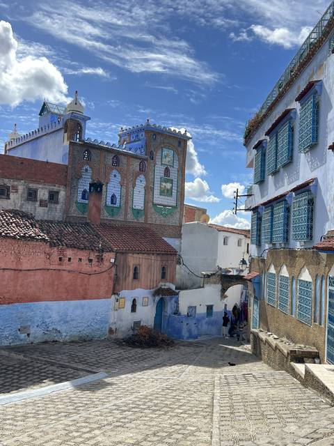 Colorful buildings with mosaic details and a clear blue sky.