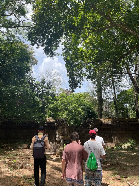 Temple ruins partially obscured by trees.