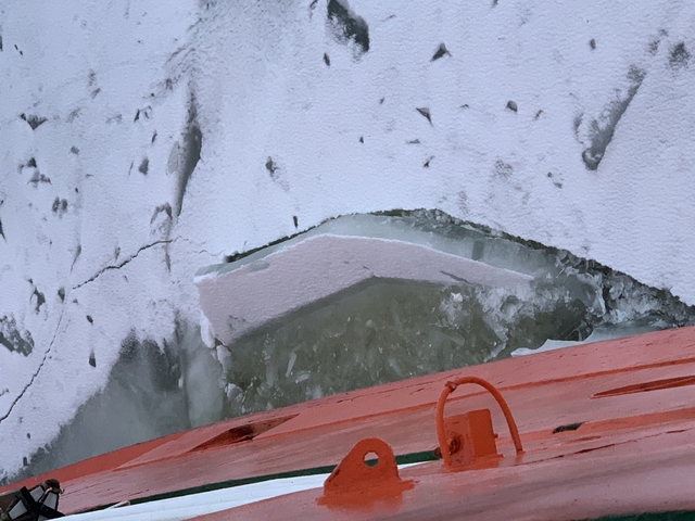 Ice fragments on a frozen body of water.