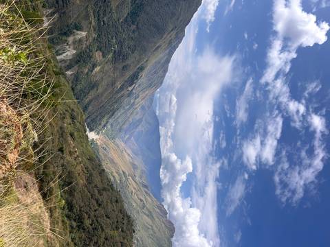 Mountain landscape with clouds and blue sky.