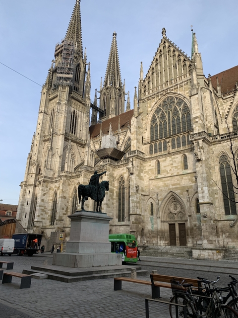 Gothic cathedral facade with a statue of a knight on horseback.