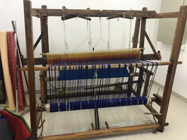 Traditional textile weaving loom in action.