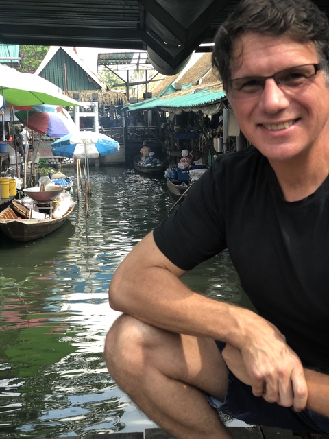 Floating market with small boats on a canal.