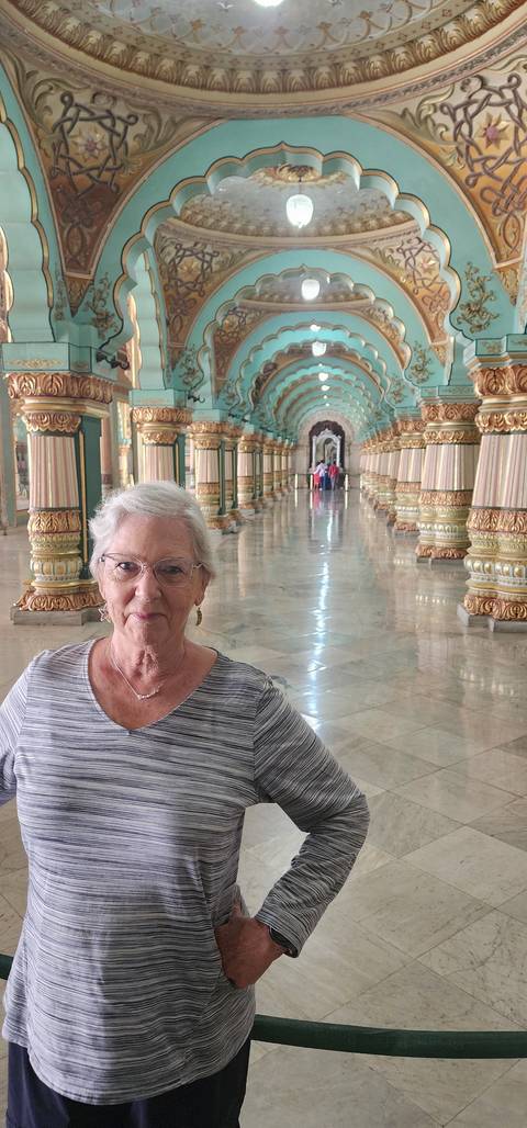 Woman standing in a colorful hallway.