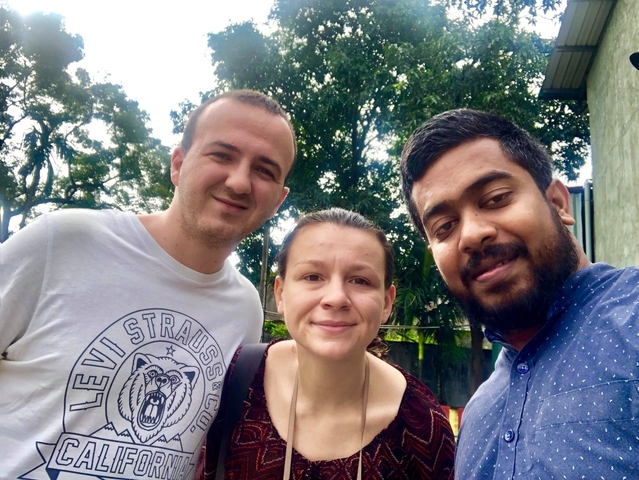 Three people posing for a selfie outdoors.