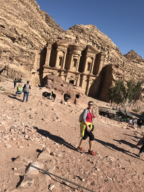 People exploring a historic sandstone monument.