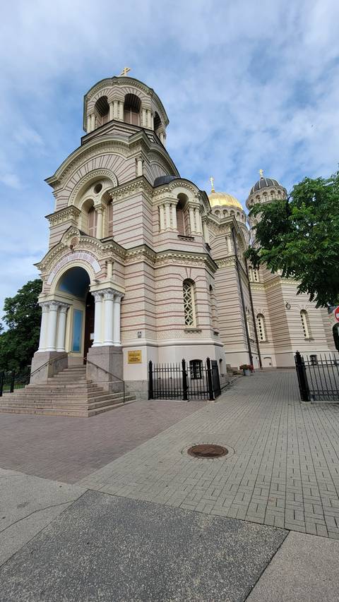 Ornate cathedral with golden dome and decorative architecture.