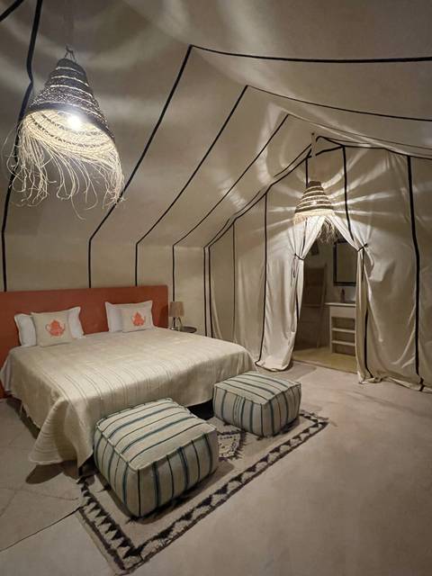 Interior of a tent with subdued colors and traditional Moroccan decor.