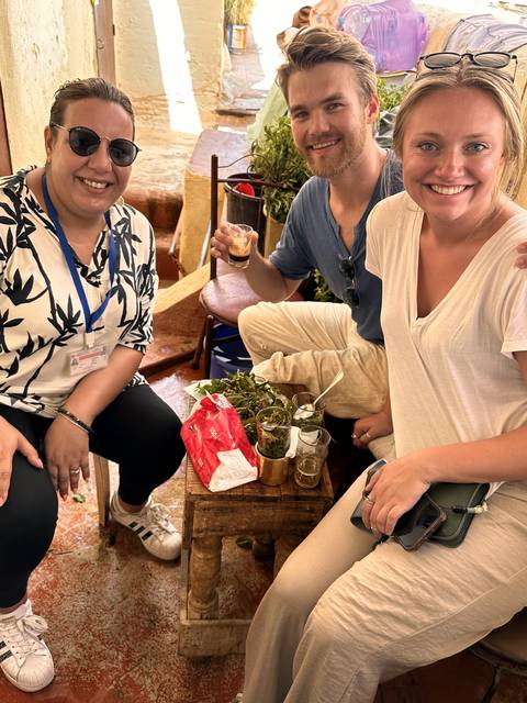 Group of people sitting together at a table with drinks.