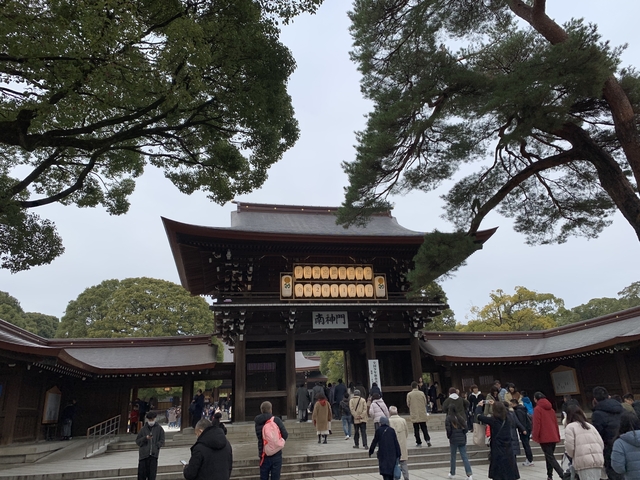 A traditional Japanese temple entrance with visitors.