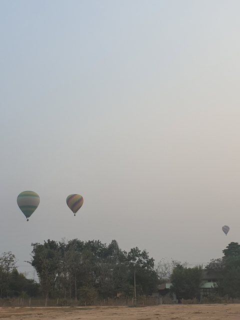 Two hot air balloons floating in a clear sky.