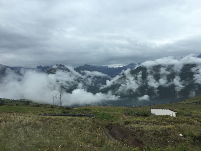 Clouds rolling over a mountainous landscape.