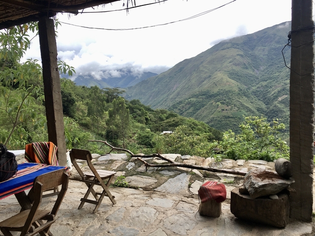 A scenic view of a mountainous landscape with a rustic patio.