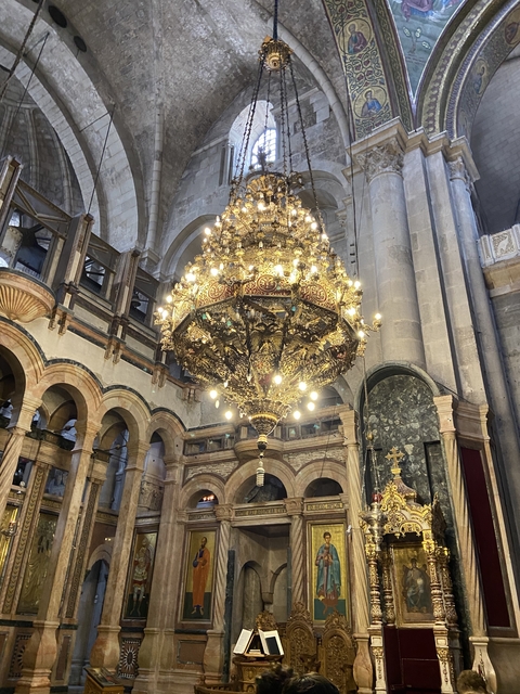 A majestic chandelier in a grand building.