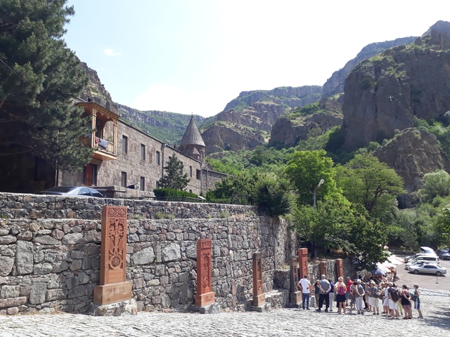 Historic building with a mountainous backdrop.
