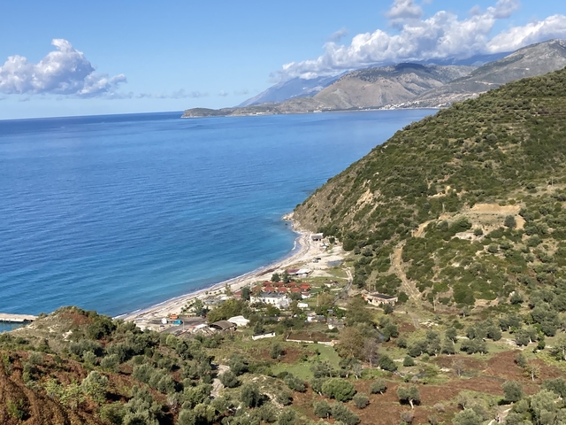 Coastal view with mountains and sea.