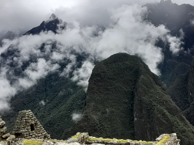 Clouds swirl around steep green Andean peaks near Machu Picchu