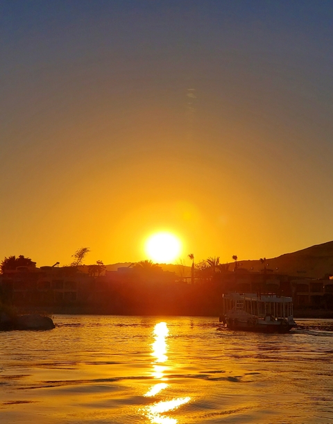 Bright sunset over a hilly landscape.
